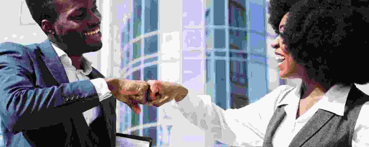 businessman and businesswoman bumping their fist - employee experience - BizEdge blog