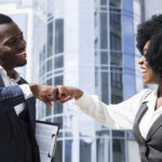 businessman and businesswoman bumping their fist - employee experience - BizEdge blog