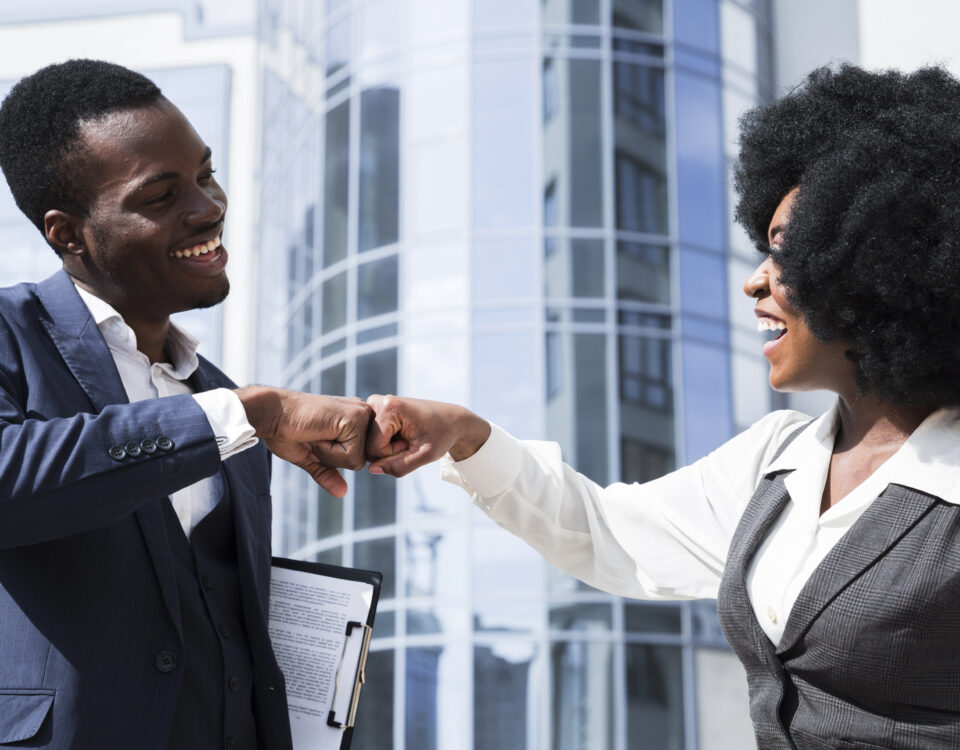 businessman and businesswoman bumping their fist - employee experience - BizEdge blog