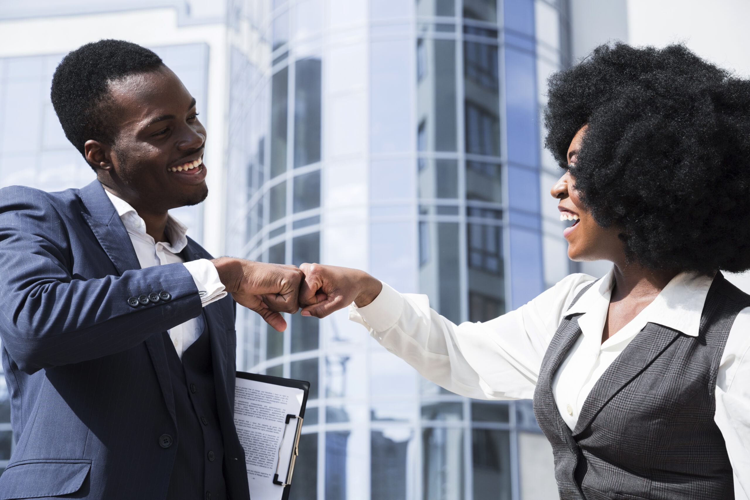 businessman and businesswoman bumping their fist - employee experience - BizEdge blog
