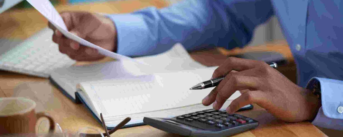 Close-up image of a man working on reports - new tax law - BizEdge blog