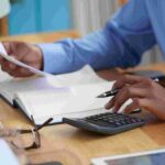 Close-up image of a man working on reports - new tax law - BizEdge blog