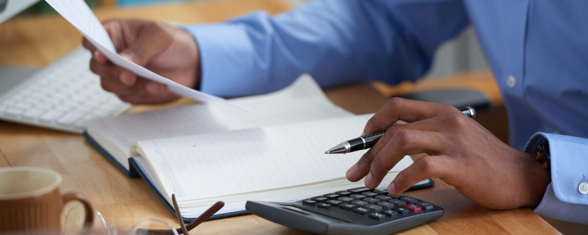 Close-up image of a man working on reports - new tax law - BizEdge blog