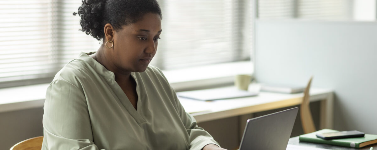 side view of a woman using her laptop - HR - BizEdge blog