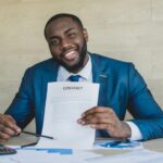 business man assessing a contract letter - employer of record - BizEdge blog