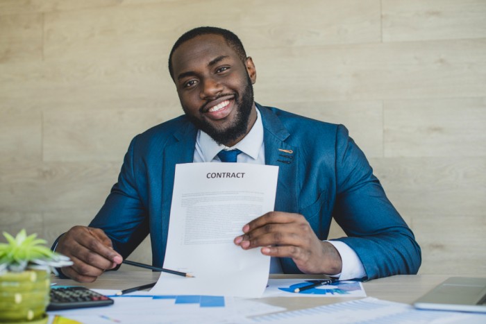 business man assessing a contract letter - employer of record - BizEdge blog