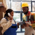 Logistics managers discussing goods distribution at work - accountability in the workplace - BizEdge blog