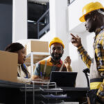 Logistics managers discussing goods distribution at work - accountability in the workplace - BizEdge blog