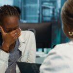 A female physician looking overwhelmed - recruitment - BizEdge Blog
