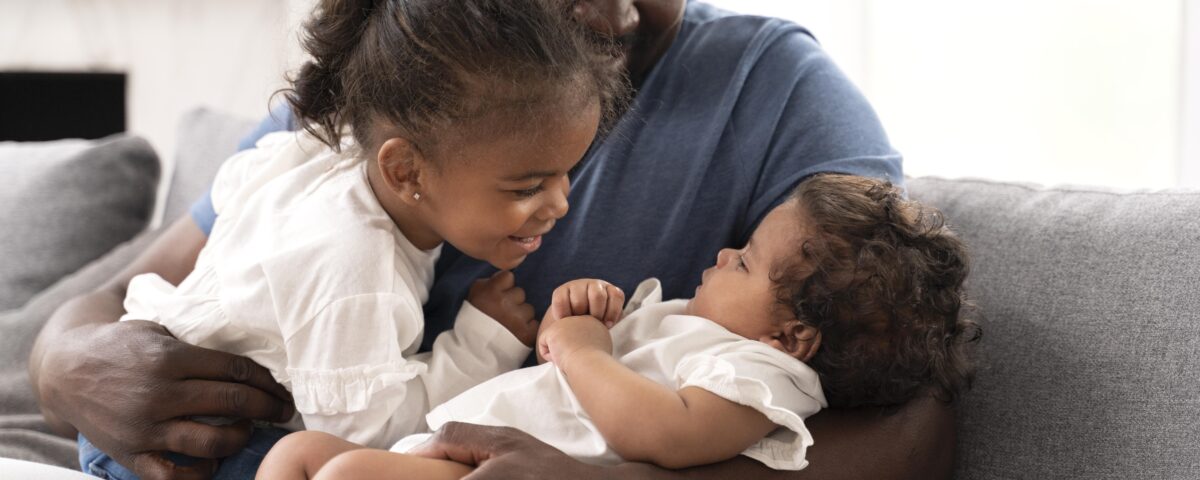 a man holding his daughter in his arms - parental leave - BizEdge blog