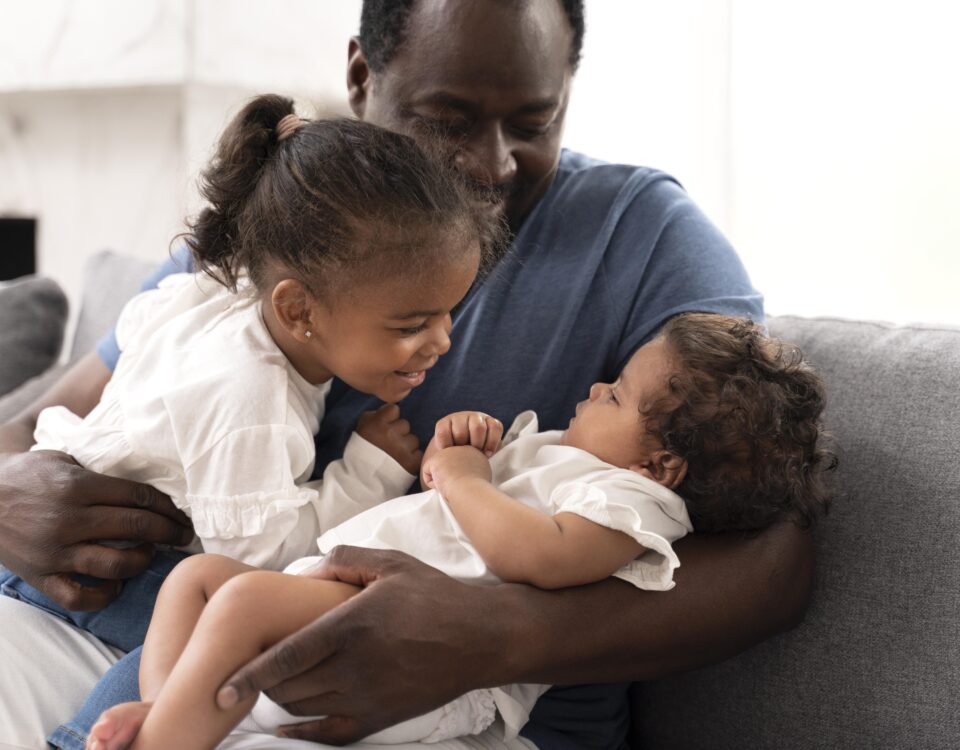 a man holding his daughter in his arms - parental leave - BizEdge blog