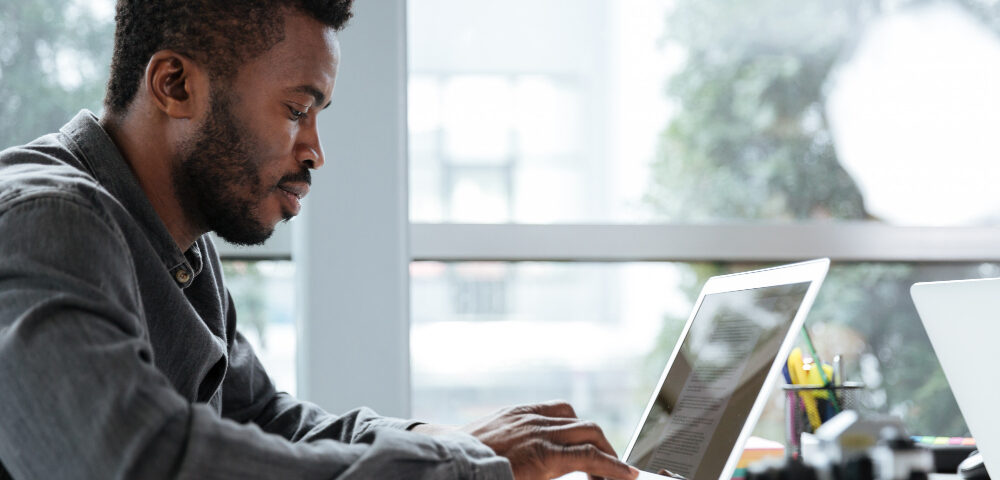 a man working on his laptop - End-to-End HR Software - BizEdge blog