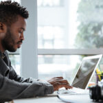 a man working on his laptop - End-to-End HR Software - BizEdge blog