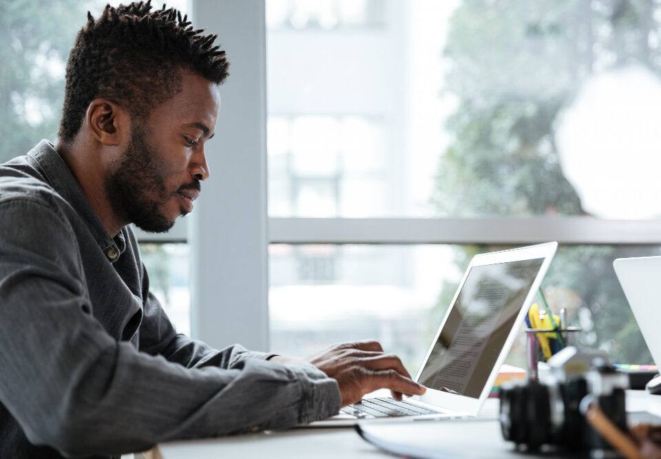 a man working on his laptop - End-to-End HR Software - BizEdge blog