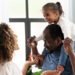 a man holding his daughter in his arms - Parental leave - BizEdge blog