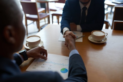 two people exhanging handshake - salary negotiation - BizEdge blog