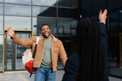 a man exhanging pleasantries with his colleague - employee time off - BizEdge blog