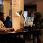 a man on his laptop with his hybrid team - hybrid workplace - BizEdge blog