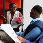 Team members sharing idea in a meeting - How to Upskill Your Workforce - BizEdge blog