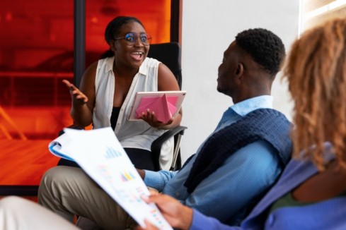 Team members sharing idea in a meeting - How to Upskill Your Workforce - BizEdge blog