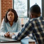 Office worker interviewing female candidate about job offer - Exit Interview - BizEdge blog