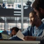 Two collegues analysing something on their computer - Digital HR - BizEdge blog