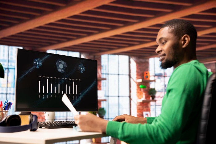5 Factors to Consider Picture of a guy using a monitor -Before Adopting an AI-Powered HR System