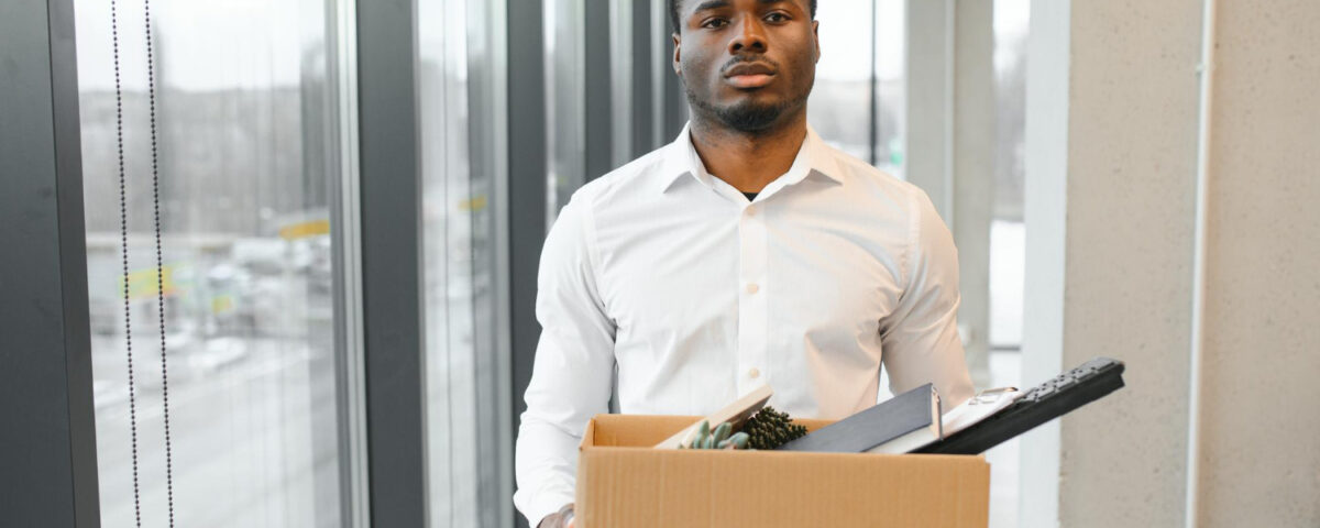 A man carrying a carton that contains his files - How Many Jobs Will AI Replace by 2030