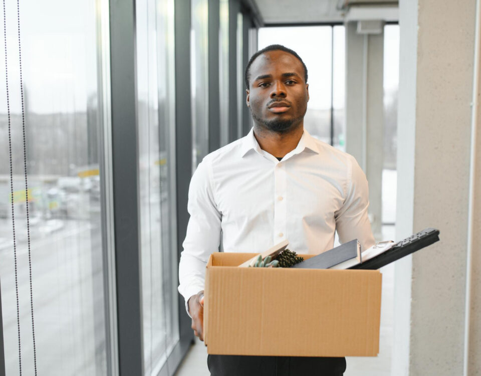 A man carrying a carton that contains his files - How Many Jobs Will AI Replace by 2030