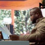A man at his desk looking at a document - Who Is Responsible for Verifying an Employee Reference Before Hiring